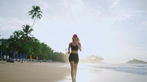 Young Blonde Woman Jogs By Sea at Sunrise Caucasian Female Runs on Beach By Ocean at Dusk Fit Sporty