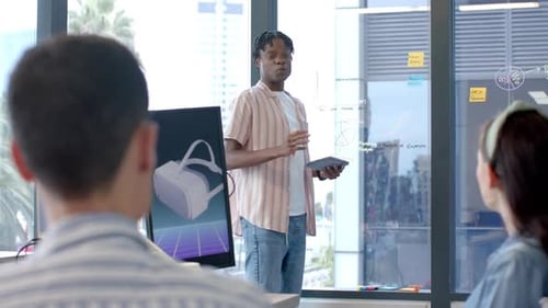 Presenting project, man holding tablet and explaining data to colleagues in office