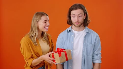 Woman Gives Birthday Gift to Happy Man