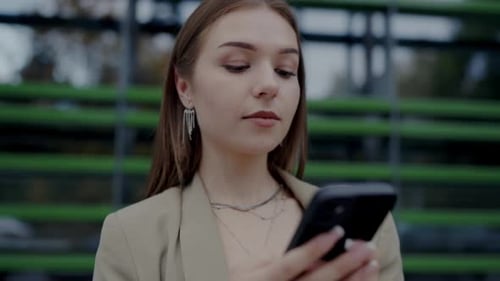 Stylish Woman Using Phone in Urban Setting