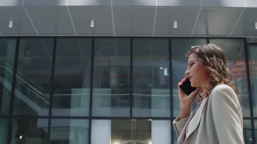 Stylish Businesswoman Walking and Talking on Phone