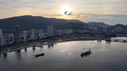 Aerial shot highlights Gurney Wharf coastline at sunset with radiant skyline