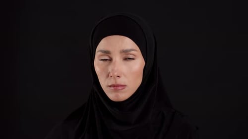 Woman in Hijab with Direct Gaze, Black Background