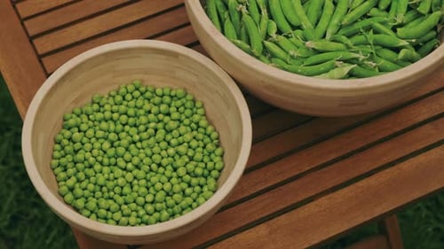 Fresh Green Peas and Pods Arranged Beautifully on a Wooden Table for a Rustic Touch
