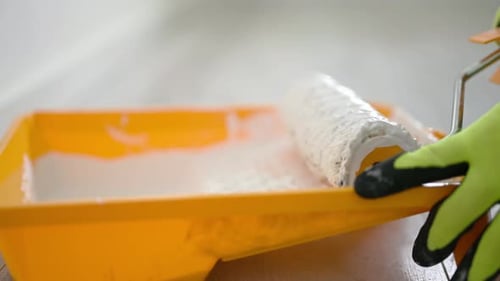 Repairman Preparing To Paint Walls With White Paint