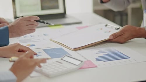 Close up of business hands are working and brainstorming on paperworks.