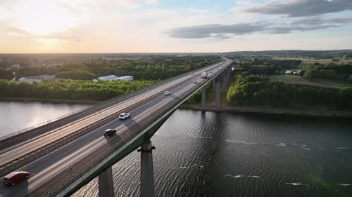 Aerial footage of traffic on the high bridge over canal. Semi-truck with a trailer, cars drive acros