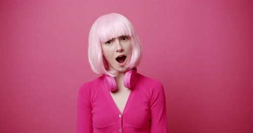 Woman in Pink Wig with Headphones Posing