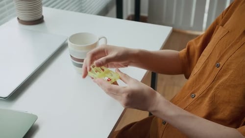 Unrecognizable Pregnant Woman Taking Pill at Office Desk