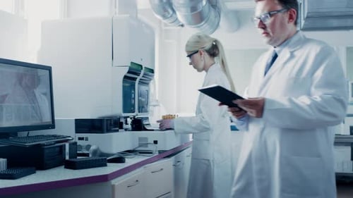 Scientists Working in Modern Laboratory with Advanced Equipment