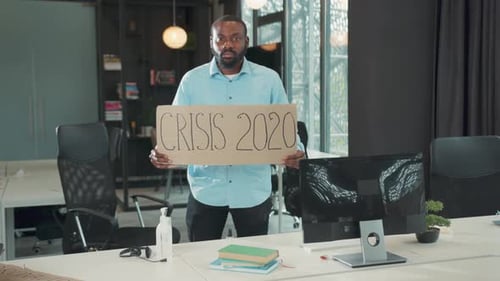 Attractive Serious African American Businessman Holding Poster Cardboard with Crisis 2020 Jobless in