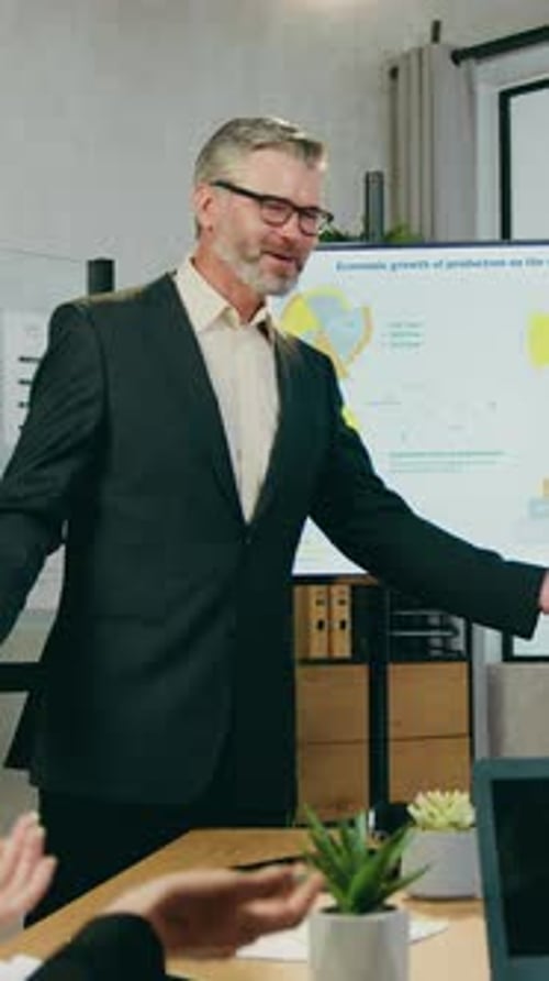 Man Presenting Business Data in Modern Office Setting