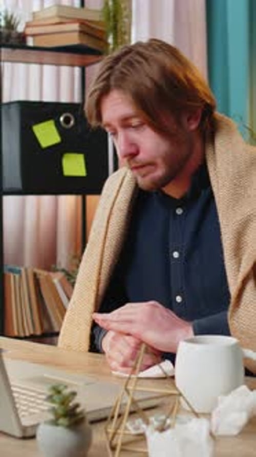 Sick Ill Young Businessman Suffering From Cold Flu or Allergy Wipes Snot Working on Laptop at Office