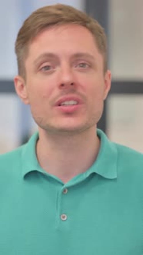 Man in Polo Shirt Talking to the Camera