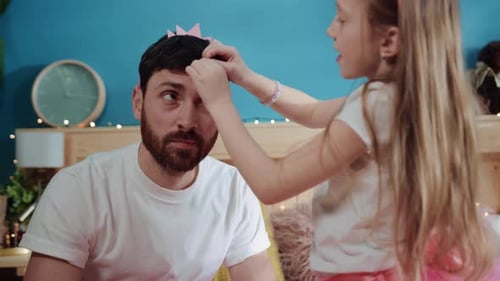 Father and Daughter Playing Dress-Up with Crown and Clips