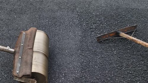 The Road Construction Crew Used Shovels and Mops to Level the Asphalt for a New Coating