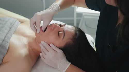Woman Receiving Facial Massage in Beauty Clinic
