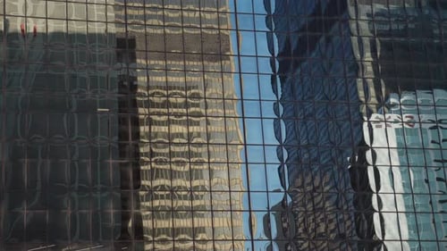 Abstract reflection in glass windows of skyscrapers and buildings in city downtown. Warped texture.