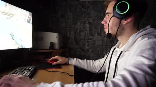 Young Adult Plays Competitive First Person Shooter Game