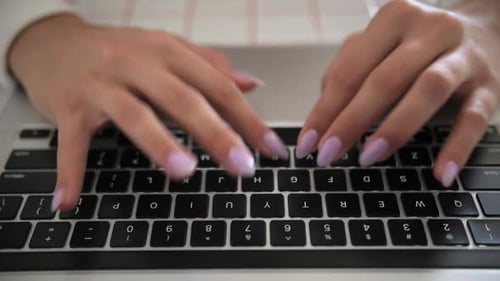 Close Up of Female Hands Typing on Laptop Keyboard at Desk