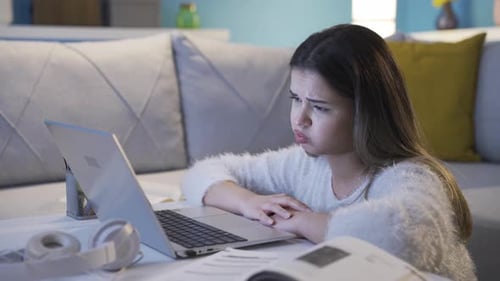 Having bad exam results, the young girl gets upset and loses her mood.