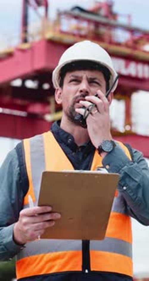 Construction, man and radio on site with clipboard for building update, engineer report