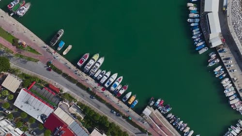 Aerial Video of a Small Yacht Harbor With Boats and Sparkling Blue Waters Surrounded By a Coastal