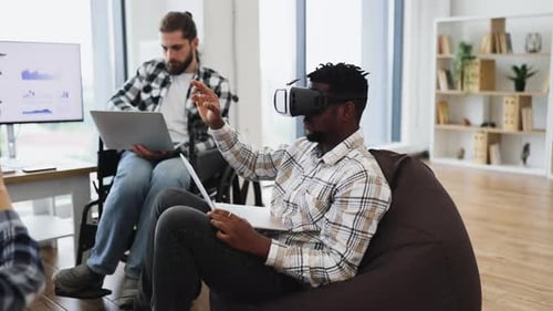 Professionals Collaborating with Virtual Reality and Laptops in Office Space