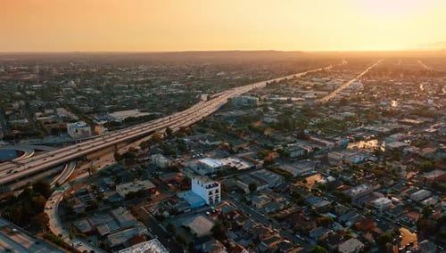 Transport flow by the highways of huge metropolis. Sunset view on the scenery of Los Angeles