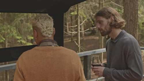 Male Friends Having Talk and Cooking BBQ on Outdoor Terrace