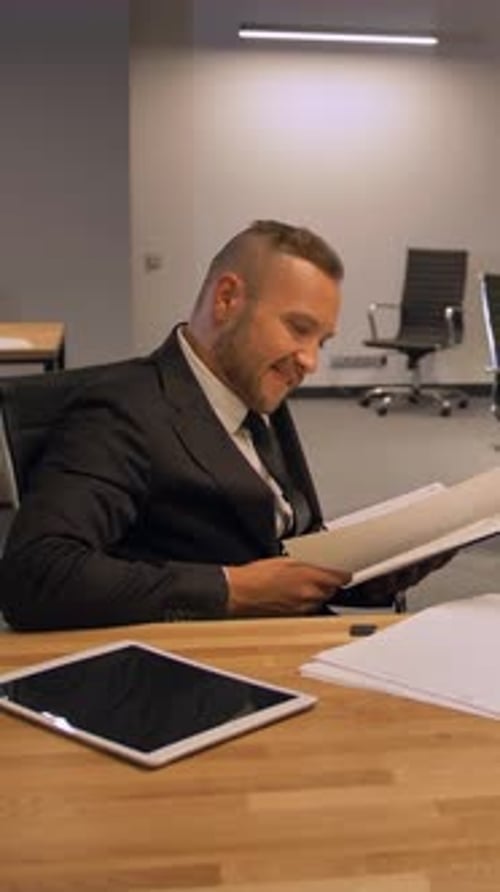 Vertical of Confident Boss Entrepreneur with Colleagues Working with Documents in Night Office