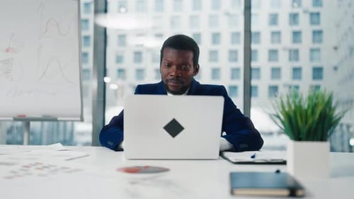 Frontal Portrait of Financial Analyst or CEO Manager in Office with Laptop African American Male