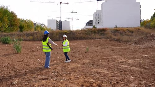 Architect and engineer walking on a construction site