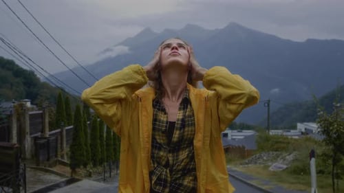 Woman with Wet Hair in Yellow Raincoat
