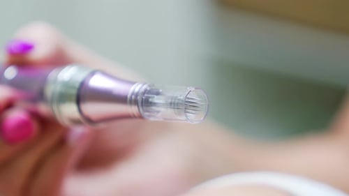 Dermapen with microneedles used for facial treatments. Close up.