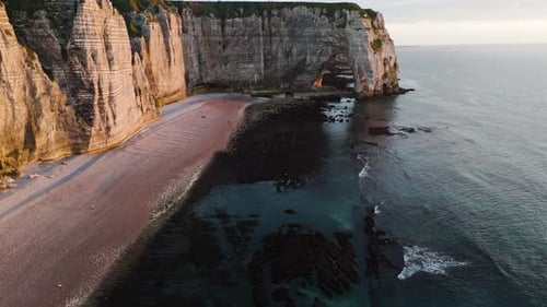 Dramatic White Chalk Cliffs Tower Above a Peaceful Beach and Ocean Arch