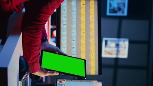 Tablet Device with Green Screen in Dark Office