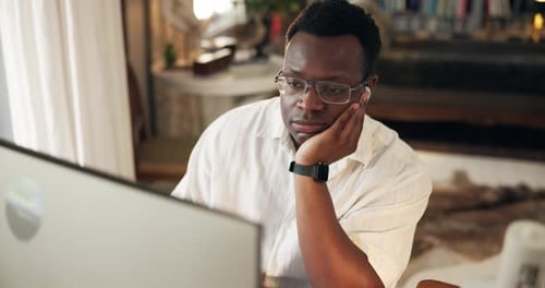 Black man, bored and computer in home for education, reading or e learning for development on web