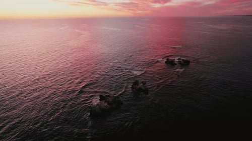 Stunning Coastal Rock Formations at Sunset Over Serene Ocean Waters