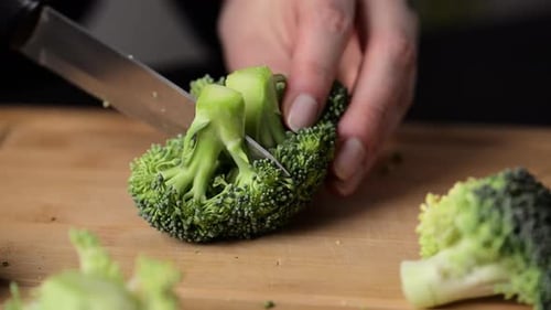 Preparing broccoli for cooking.