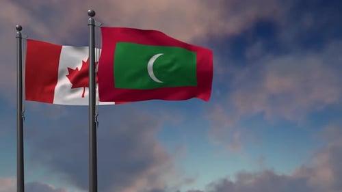 Canada and Maldives National Flags Waving Against Blue Sky