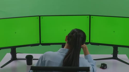 Asian Woman Having Headache While Working With Mock Up Multiple Computer Monitor In Green Screen