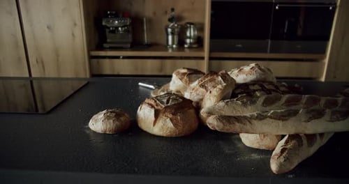 Modernes und geräumiges Küchenzimmer aus Holz mit vielen Brotsorten auf dem Tisch