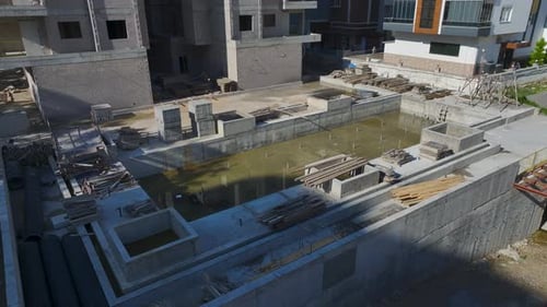 Vídeo aéreo de una grúa que entrega hormigón a un bloque residencial