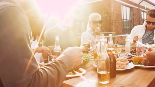 Group enjoys outdoor barbecue with salads and burgers