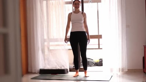 Woman Stretching on Yoga Mat at Home