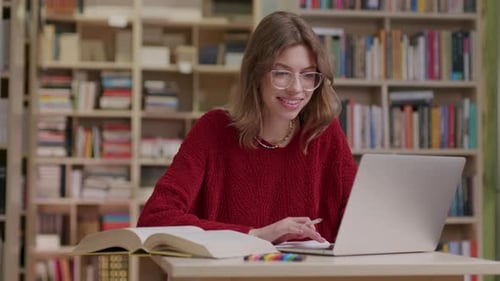 Studying In Library With Laptop