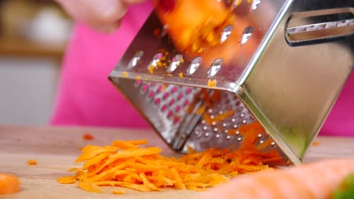 Grating a Carrot with a Metal Grater