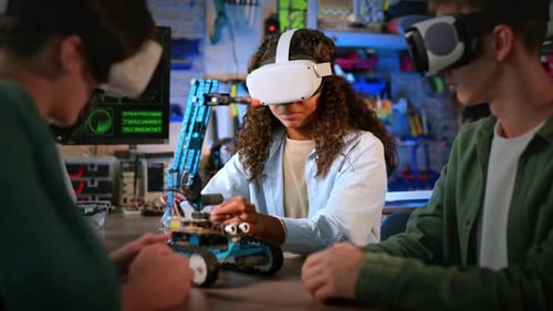 Group of young people in VR glasses doing experiments in robotics in a laboratory. Robot on the tabl