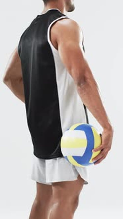 Man Holding Volleyball in Studio